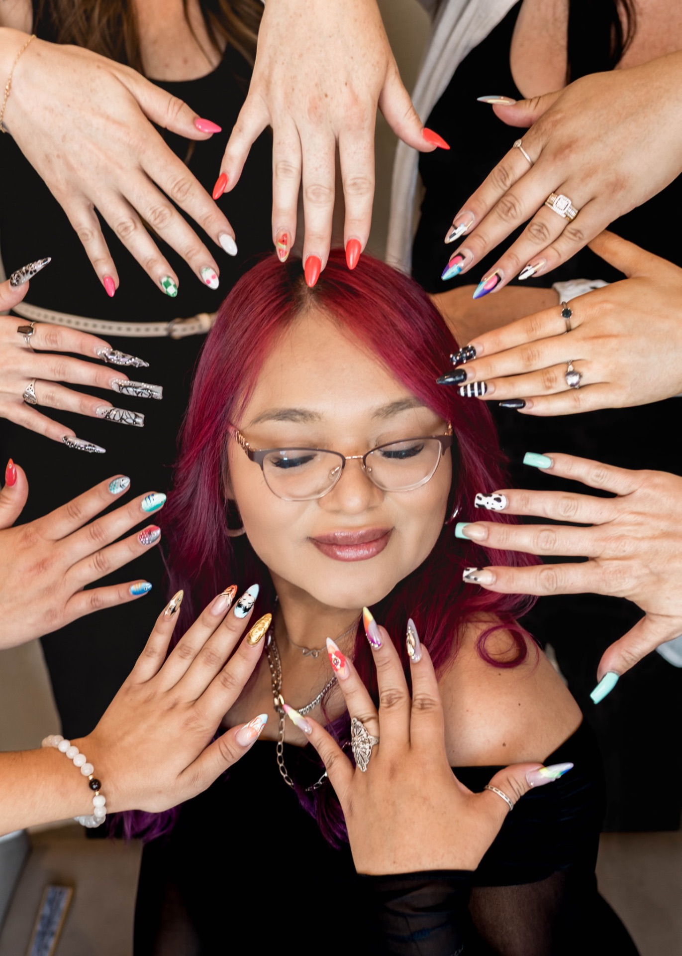 Brisa surrounded by nail art from the Elite Beauty team